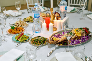 A Lavish Feast Spread Featuring Colorful Dishes, Fresh Ingredients, and Elegant Table Settings with Glimmering Glassware and Soft Candlelight Ambiance
