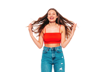 Joyful young woman in red top laughing ecstatically while tossing her long brown hair.