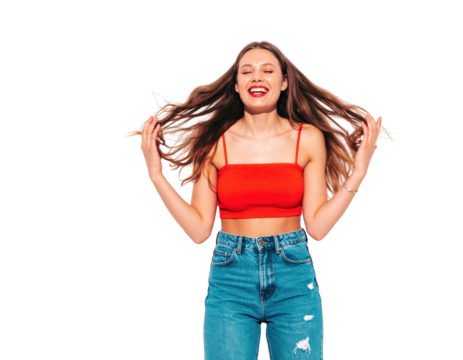 Joyful young woman in red top laughing ecstatically while tossing her long brown hair.