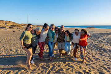 Group of people walking on the beach at sunset after spiritual retreat