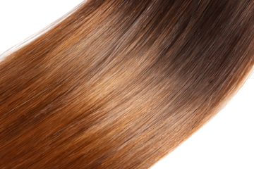 Close up view of long brown and blonde hair with a smooth transition in color and a sleek texture