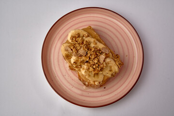 Deliciously Rich Banana Toast with Creamy Nut Butter and Crunchy Granola Perfect for Breakfast or Snack Anytime of the Day