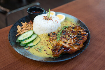 Coconut steamed rice with bbq chicken on a plate. Asian food. 