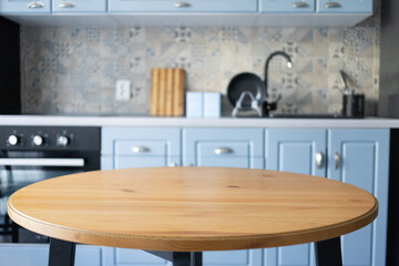 Fototapeta premium blurred kitchen interior and wooden desk space home background