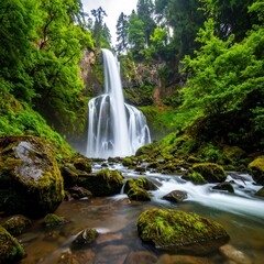 Naklejka premium Lush waterfall cascading down rocky gorge