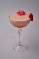 Deliciously Elegant Dessert Cocktail with Whipped Cream and Fresh Strawberry Garnish in a Crystal Glass