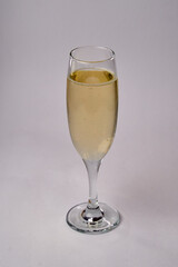 A Delightful Glass of Sparkling Beverage Reflecting Elegance and Celebration in a Tall Crystal Flute with Consistent Bubbles and a Light Golden Hue