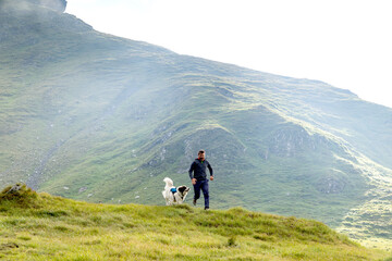 Obraz premium trekking with a dog in high mountains