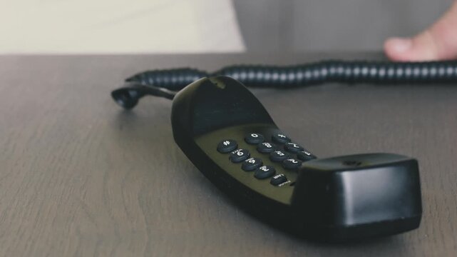 Man hesitates before throwing phone on table during important conversation in quiet office