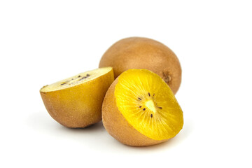 Fototapeta premium Fresh golden kiwi fruit, whole and sliced, showcasing vibrant yellow flesh and tiny black seeds, arranged on a clean white background for appealing presentation and culinary use