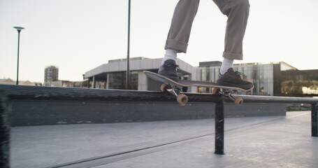 Skateboard, legs and balance on rail at park for grind trick, training performance and challenge. Skater, person and talent in city with skating workout, hobby and practice action stunt at skatepark