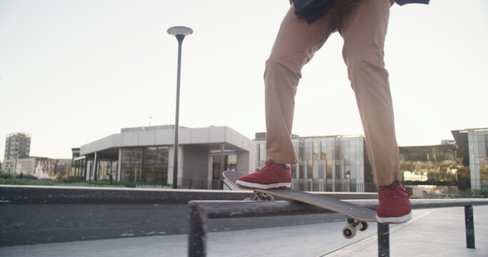 Skateboard, legs and balance on rail at skatepark for grind stunt, training performance or workout. Skater, person and talent in city with skating challenge, hobby and practice action trick outdoor