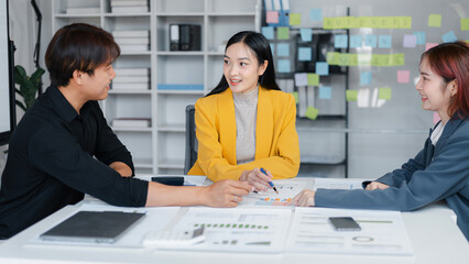 Business Meeting Collaboration Asian Team Analyzing Graph Chart Documents for Project Plan Strategy on White Board in Modern Office Workspace Discussion