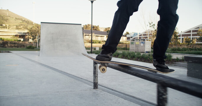 Skateboard, skater and legs with balance on rail for grind stunt, performance challenge and skill. Extreme sport, person and skating at skatepark for workout, hobby and practice action trick at ramp - Powered by Adobe