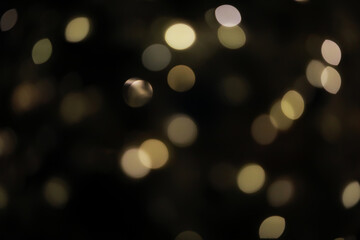Abstract Blurred Golden and White Bokeh Lights in Dark Background for Festive and Holiday Themes
