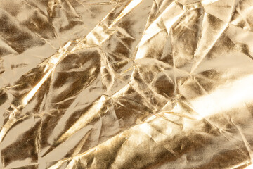 Crumpled Golden Aluminum Foil Texture Background