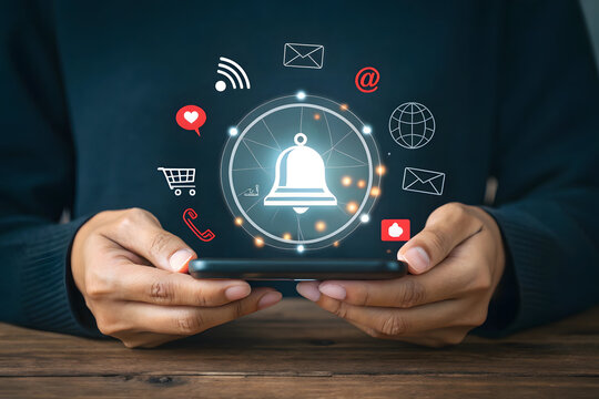 Person holding smartphone with digital notification icons and central bell symbol mobile phone technology