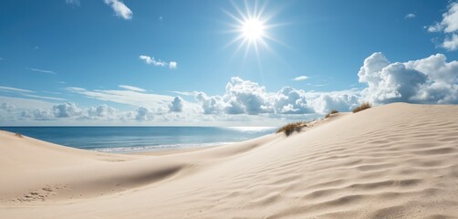 Sand dunes meet calm blue ocean under a bright sunny summer sky. Rippling sand patterns, sparse dune grass, and distant waves evoke a sense of tranquil coastal beauty and warm vacation vibes.