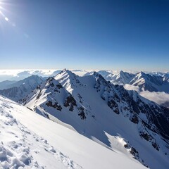 Fototapeta premium Snow-covered mountain range under a clear blue sky, sunlit peaks and shadows