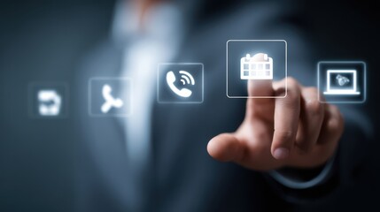 A man in a suit uses a touchscreen to engage with various digital icons representing communication and scheduling tools. The modern office environment enhances the professional atmosphere