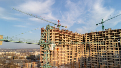 Tower cranes working on high-rise residential construction site
