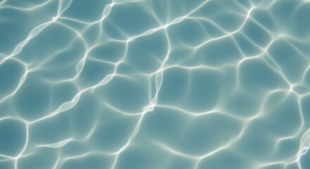 Sunlight dances on the tranquil surface of clear turquoise water creating an ethereal and mesmerizing abstract pattern