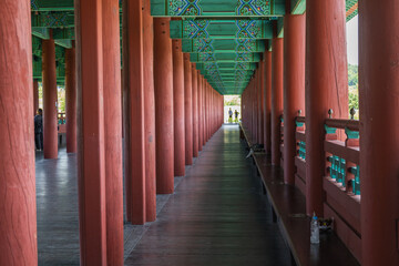 View of the historic Wolji Bridge with red columns and colorful green beams in Gyeongju, South Korea