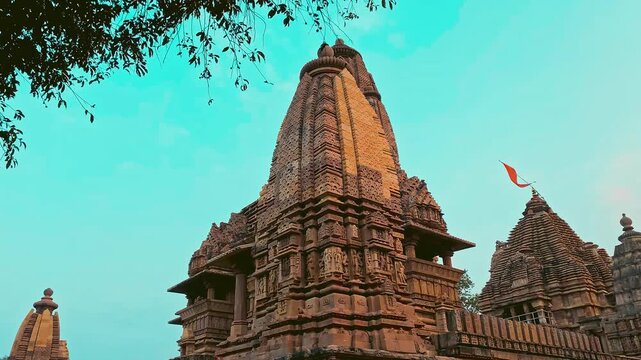 Khajuraho, presented in a cinematic vision, showcasing its ancient temples, intricate sculptures, and sacred ambiance through dramatic visuals.