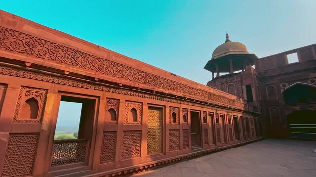 Agra Fort in Agra, India, is a massive red sandstone fortress with rich Mughal history, intricate architecture, and stunning views of the Taj Mahal.