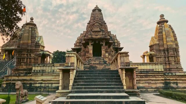 Khajuraho temples captured in a cinematic style, emphasizing their ancient elegance, intricate carvings, and spiritual atmosphere for dramatic visual storytelling.