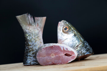Slice raw  Rohu fish or Rui fish isolated on black background
