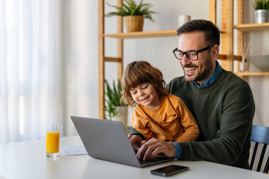 Remote business man, single parent multitasking with child at home. Productive single father online - Powered by Adobe