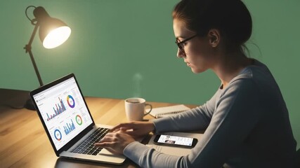 Young woman analyzing financial data on laptop with graphs in a home office setting - Powered by Adobe