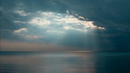 Dramatic Sky Over Still Waters with Sun Rays Piercing Through the Clouds
