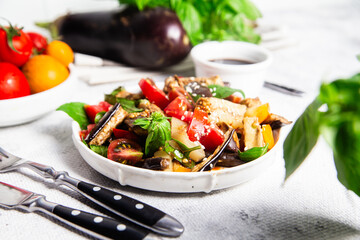 Fresh Eggplant Salad with Tomatoes and Basil on White Plate