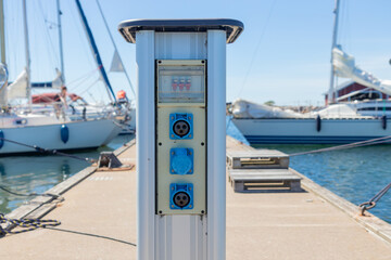 Charging station for boats at a marina pier in Finland, with electrical outlets for powering...