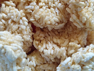 Stacks of rengginang, a traditional Indonesian snack made from fried sticky rice, display a crunchy...