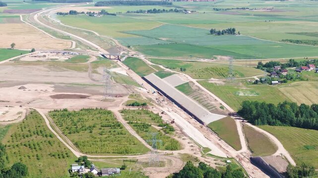 Rail Baltica railway spanning in Lihuania farmlands, aerial view