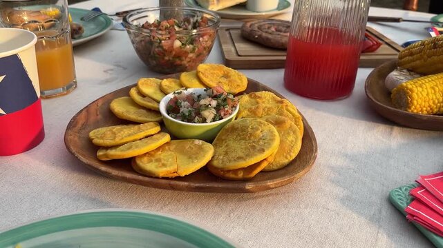 Fiestas Patrias chile grill parrilla meat chorizo table empanadas pebre sopaipillas