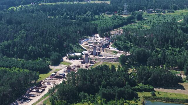 Massive railway bridge construction project in woodland of Lithuania, aerial view