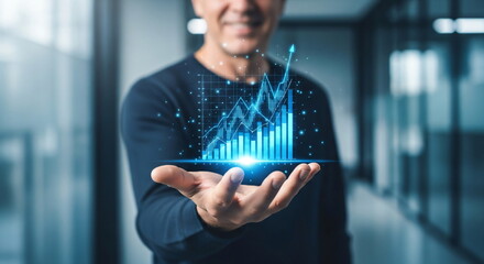 Man showing a bright digital business graph with an upward arrow. Financial success and growth data visualization for sales.