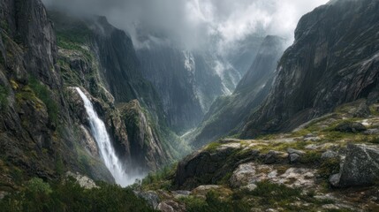 Verdant valley landscape with steep cliffs, waterfall, and mist-shrouded peaks above