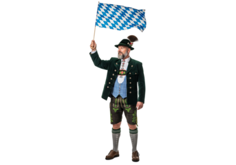 PNG cut out isolated background. A full-length portrait of a proud man in full, traditional Bavarian attire, including lederhosen and a hat, smiling while waving the blue and white checkered flag.
