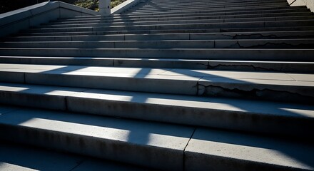 Sunlit concrete stairway showcasing geometric shadows and textural nuances on aged treads
