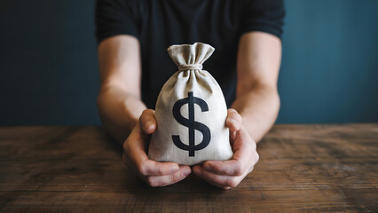Man holding a money bag with a dollar sign, symbolizing wealth and financial success.