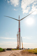 Obraz premium wind turbines in the wind park under construction in the Samara region in the sunflower field