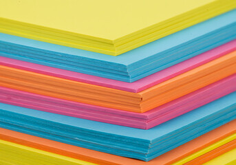 Stack of vibrant colored paper sheets for office or creative use