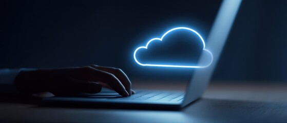 The laptop displaying a glowing cloud symbol in a dimly lit environment.