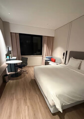 Serene minimalist hotel room exuding crisp tranquility, ideal for National Relaxation Day or Hygge-inspired Thanksgiving retreats