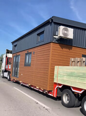Mobile tiny house journey, eco-conscious living on wheels, downsized escape, Micro-Living Day, embracing minimalism, nomadic lifestyle trend